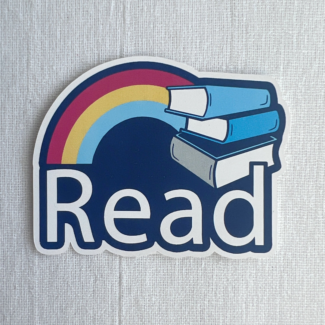 A three-inch sticker of a rainbow, a stack of three books and the word, "Read" on a blue background