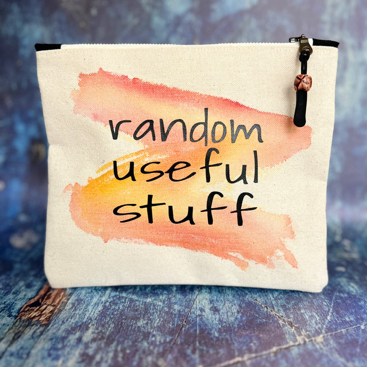 square canvas zipper pull bag with the words, random useful stuff