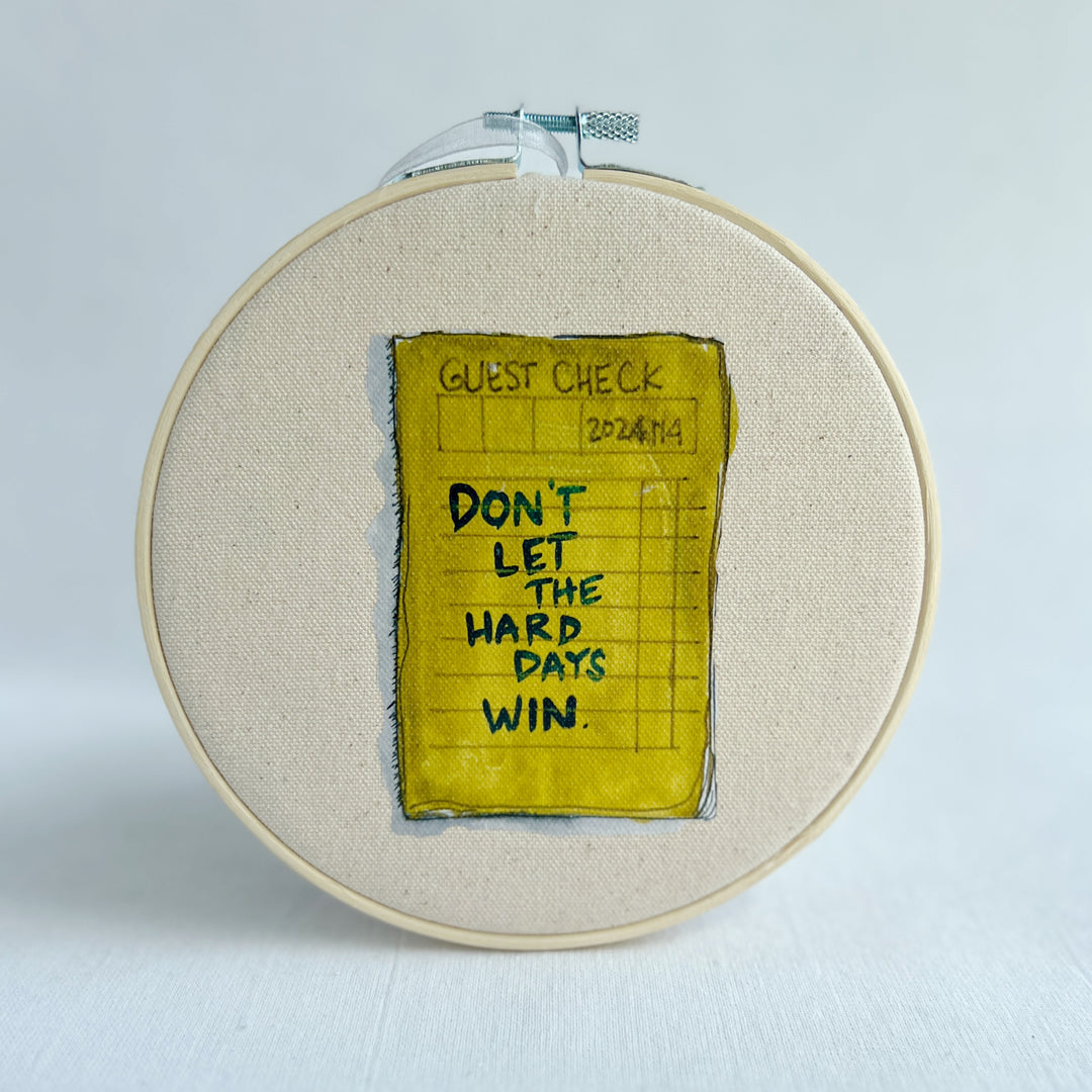 oatmeal linen canvas with a guest check design in deep citron, with the words, Don't let the hard days win