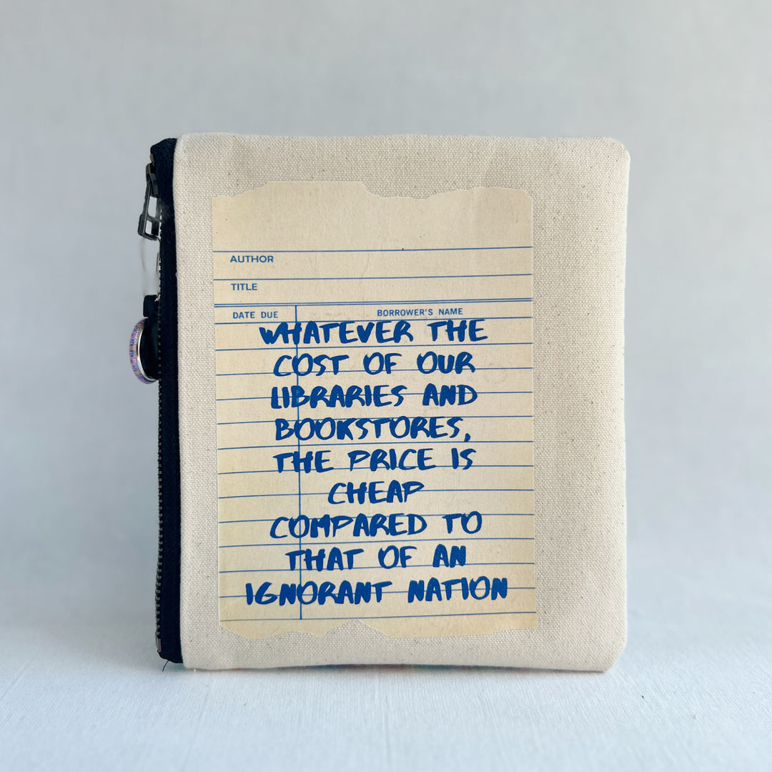 padded canvas zip bag with a linen library card and the words, whatever the cost of our libraries and bookstores, the prices is cheap compared to that of an ignorant nation, plus a colorful zipper pull and lining