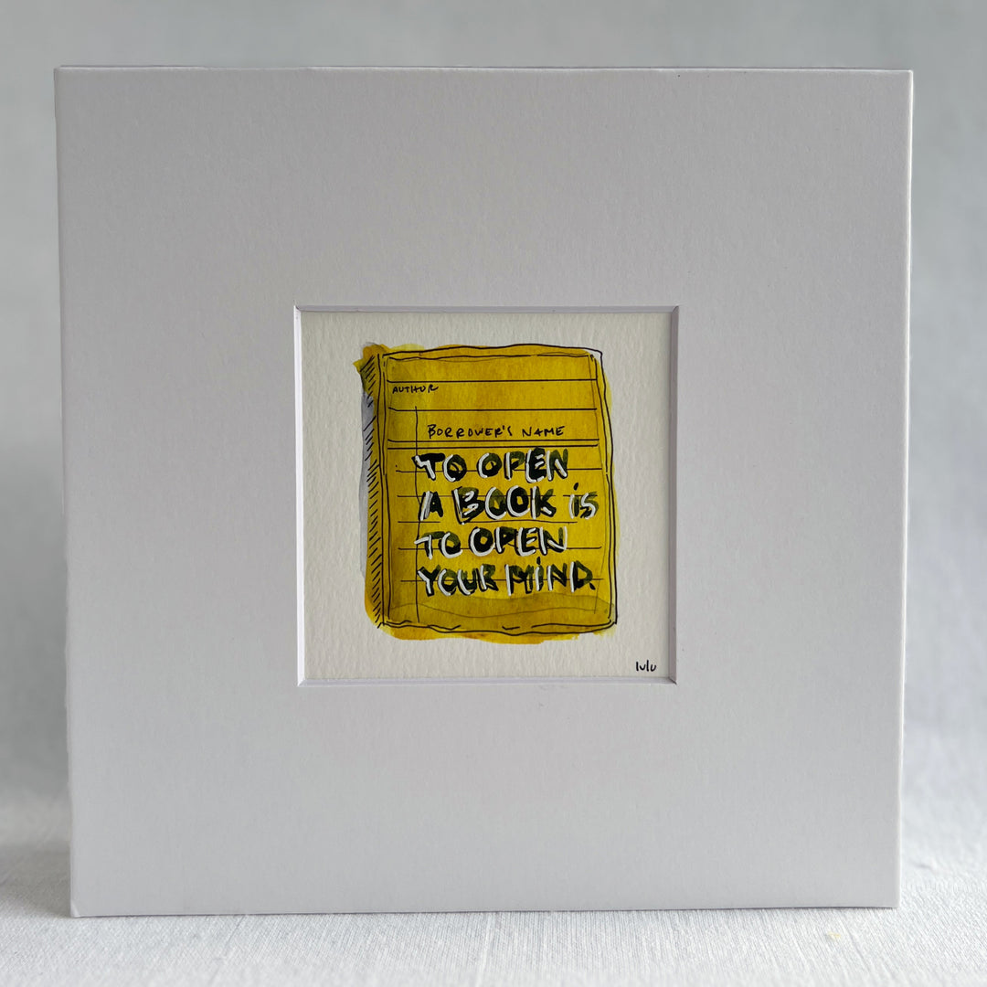 an original watercolor painting depicting a torn vintage library checkout card in shades of yellow with the words, to open a book is to open your mind, matted in white