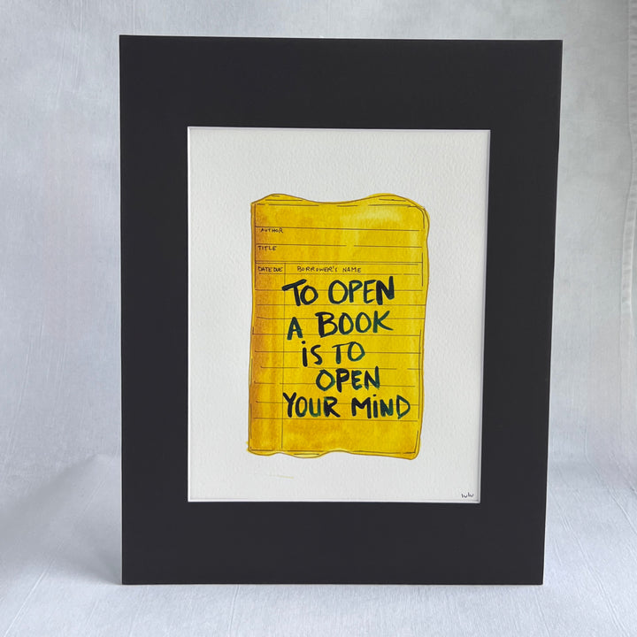 an original watercolor painting depicting a torn vintage library checkout card in shades of yellow with the words, to open a book is to open your mind, matted in black