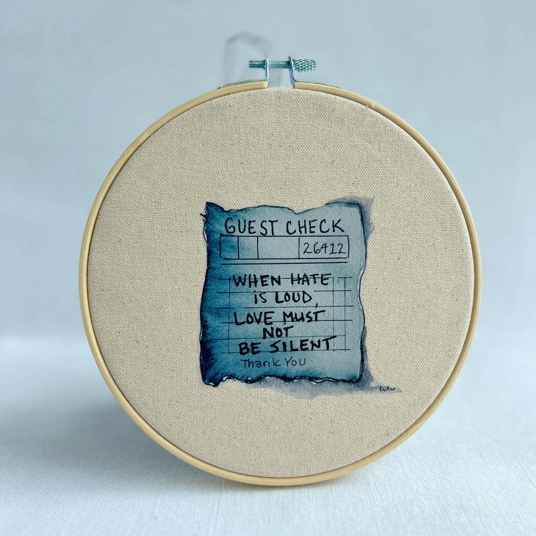 oatmeal linen canvas with a guest check design in deep blue-grey, with the words, when hate is loud, love must not be silent.