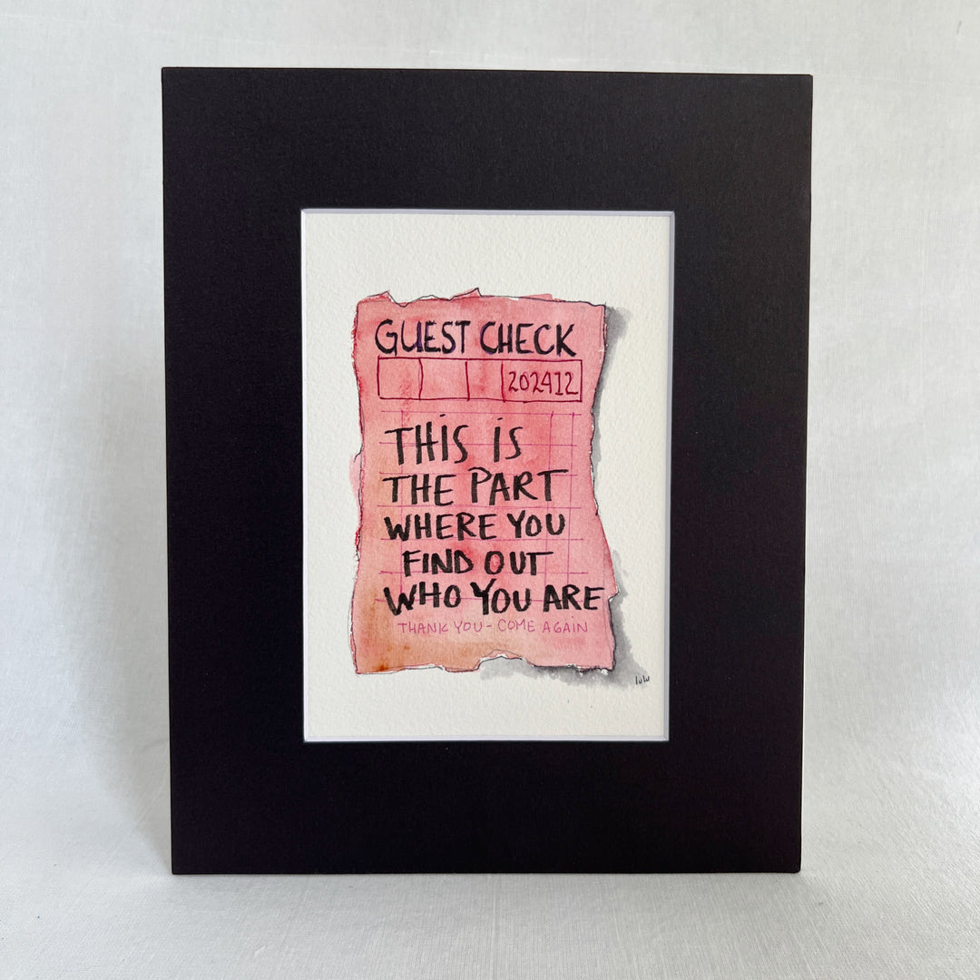 an original watercolor painting in shades of red and vintage pink, depicting a vintage crumpled diner guest check with the words, this is the part where you find out who you are, matted in black